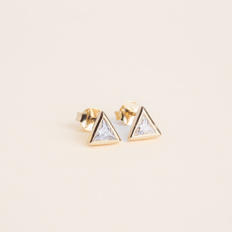 a pair of triangle shaped earrings on a white background