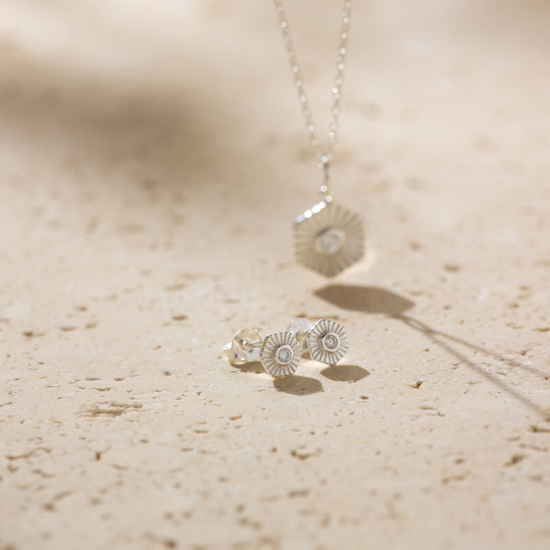 a pair of earrings sitting on top of a table