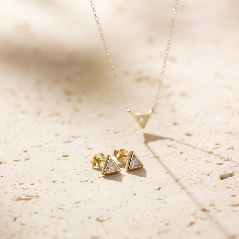 a pair of earrings sitting on top of a table