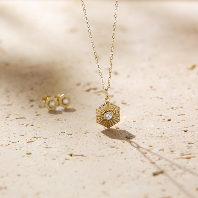 a pair of earrings and a necklace on a table