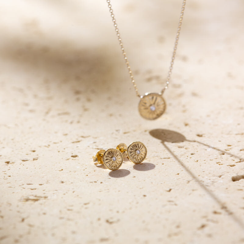 a pair of earrings sitting on top of a table