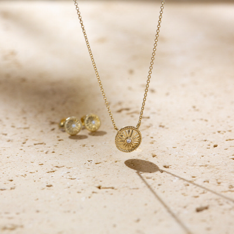 a couple of necklaces sitting on top of a table