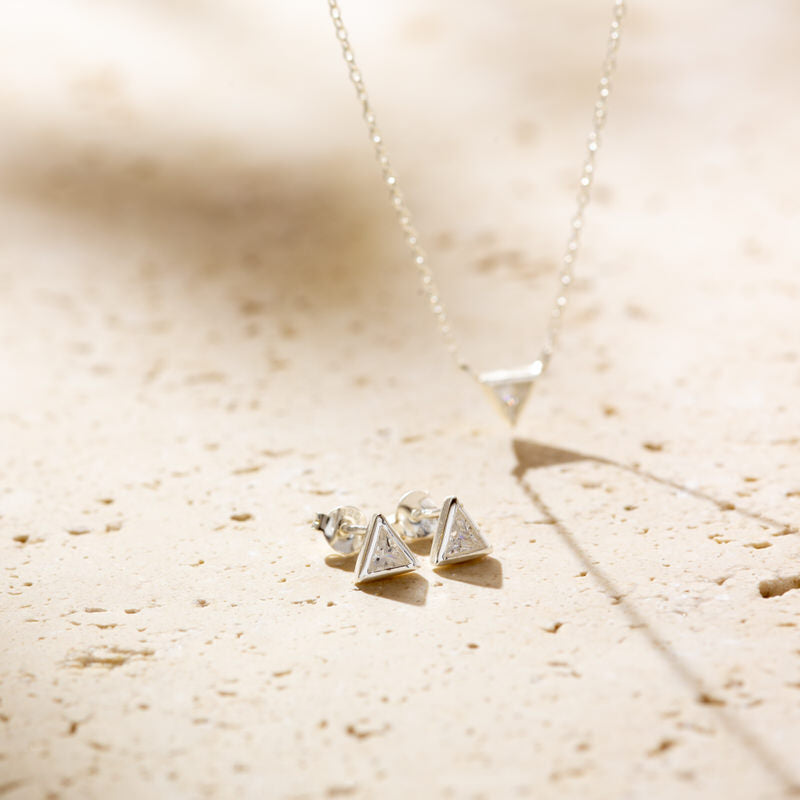 a pair of earrings sitting on top of a table