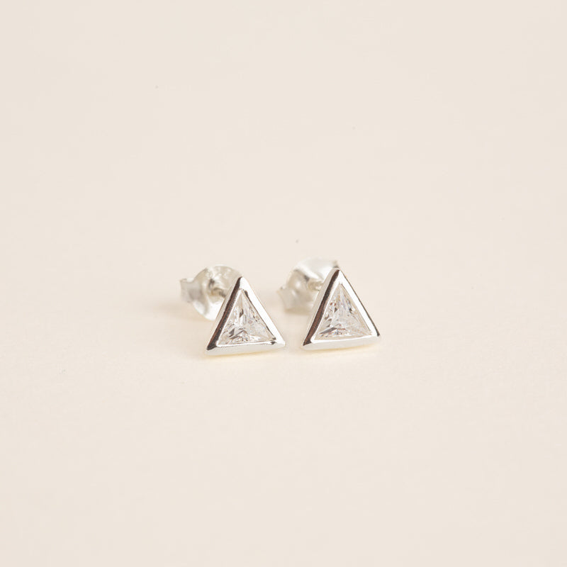 a pair of triangle shaped earrings on a white background